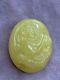 Natural Baltic Amber cabochon with lion carving. Egg yolk